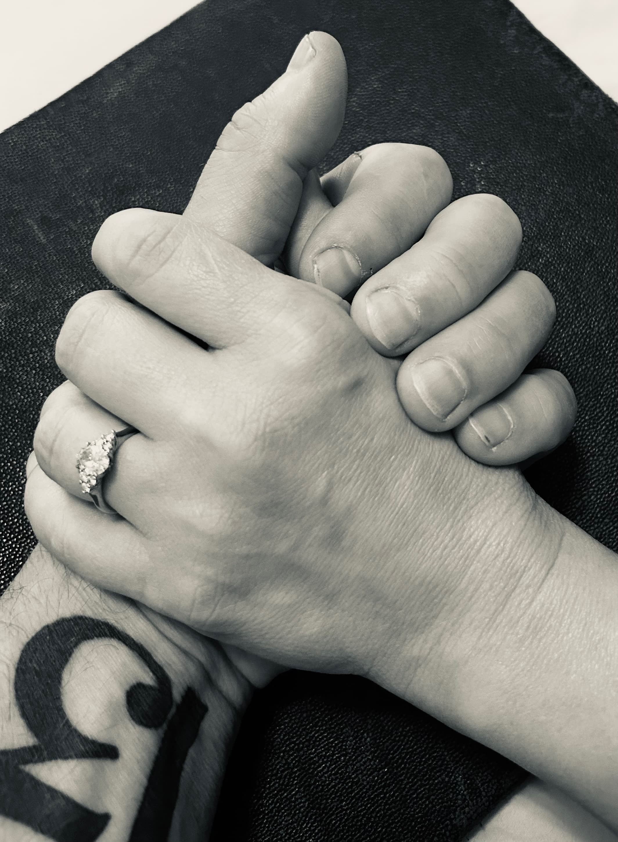 Heidi and Jon, hands clasped, engagement ring